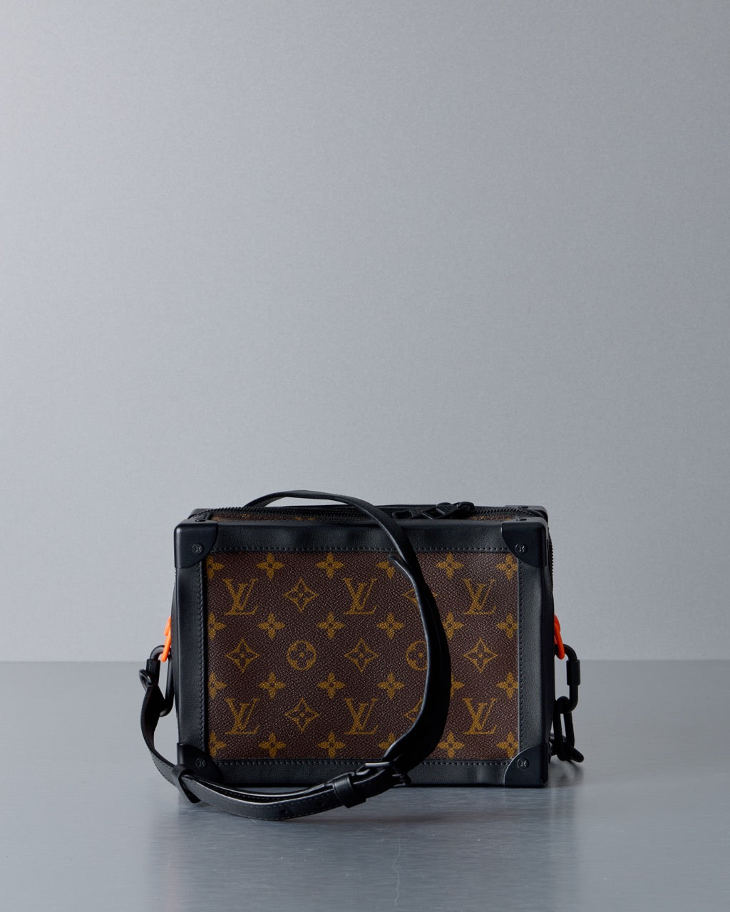 Louis Vuitton monogram bag on a gray background