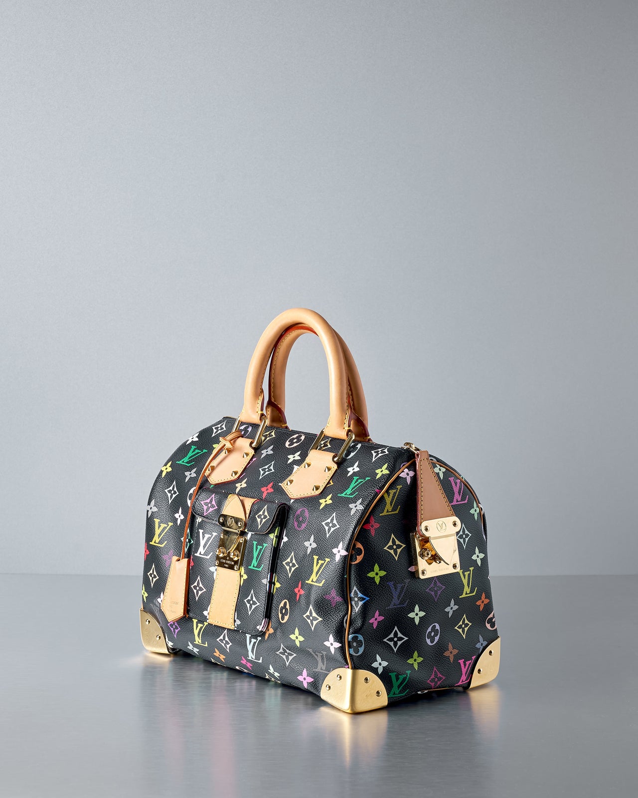 A multicoloured Louis Vuitton Speedy 30 top-handle bag with tan leather detailing and gold hardware.