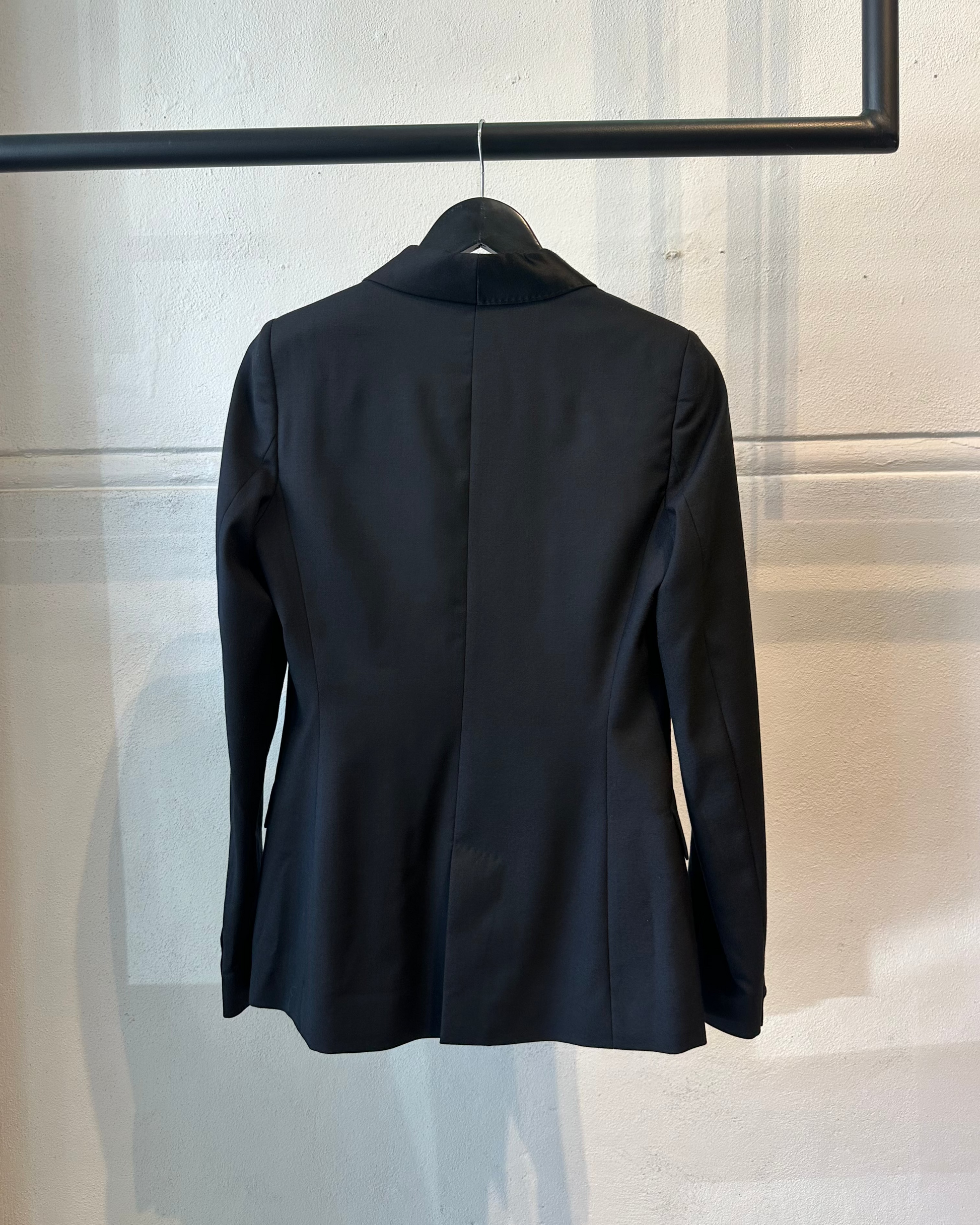 Black Maison Margiela blazer on a hanger against a neutral background