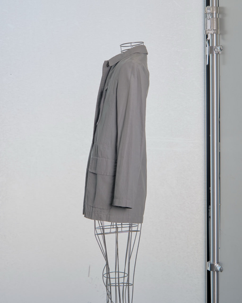 Gray Maison Margiela blazer on a mannequin against a white wall