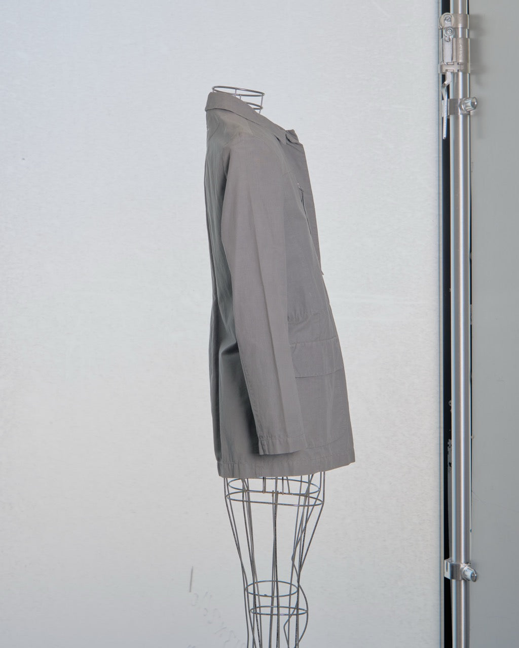 Gray Maison Margiela blazer on a mannequin against a white background
