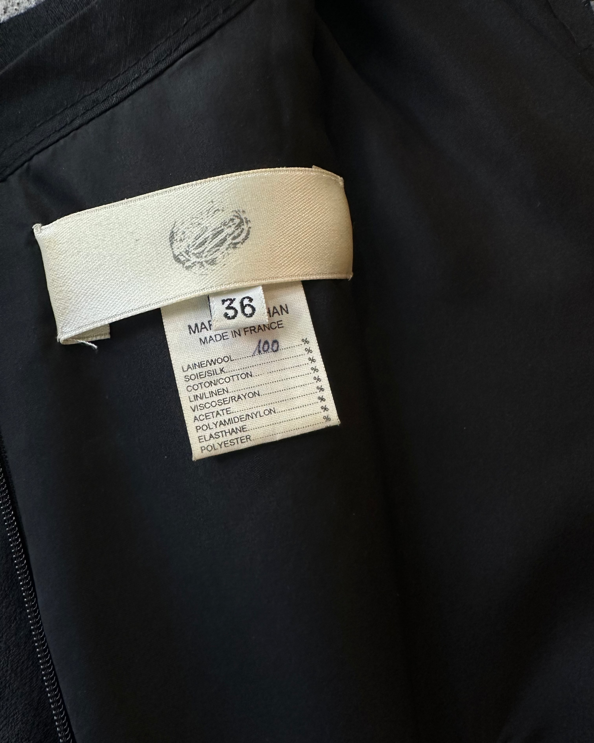 Clothing tag on a black Marc Le Bihan garment with brand logo and text.