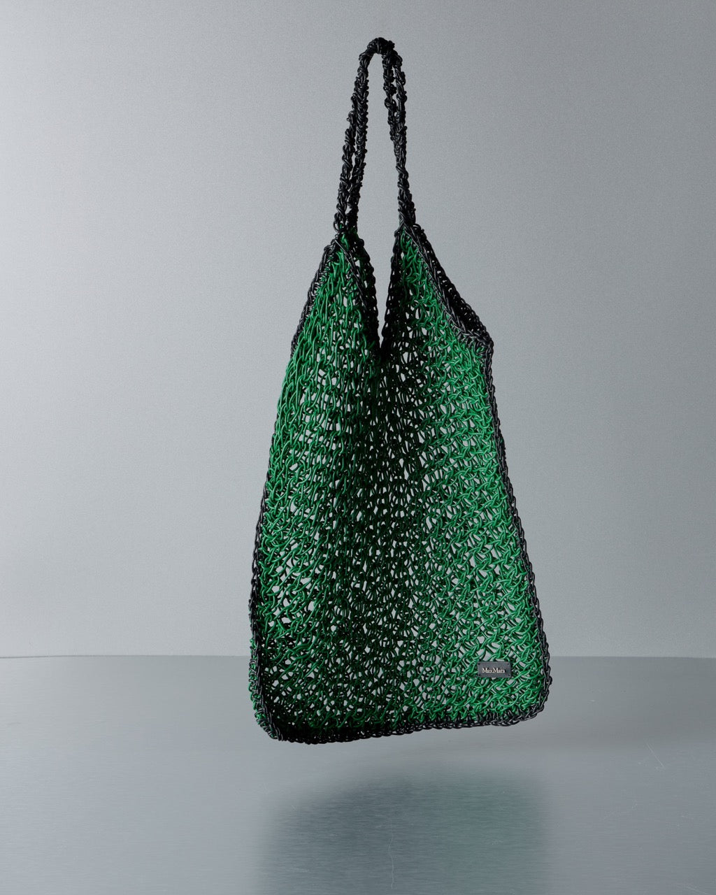 Green textured Max Mara handbag on a gray background
