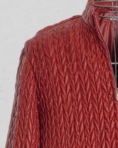 Quilted red Miu Miu jacket on a mannequin against a light gray background