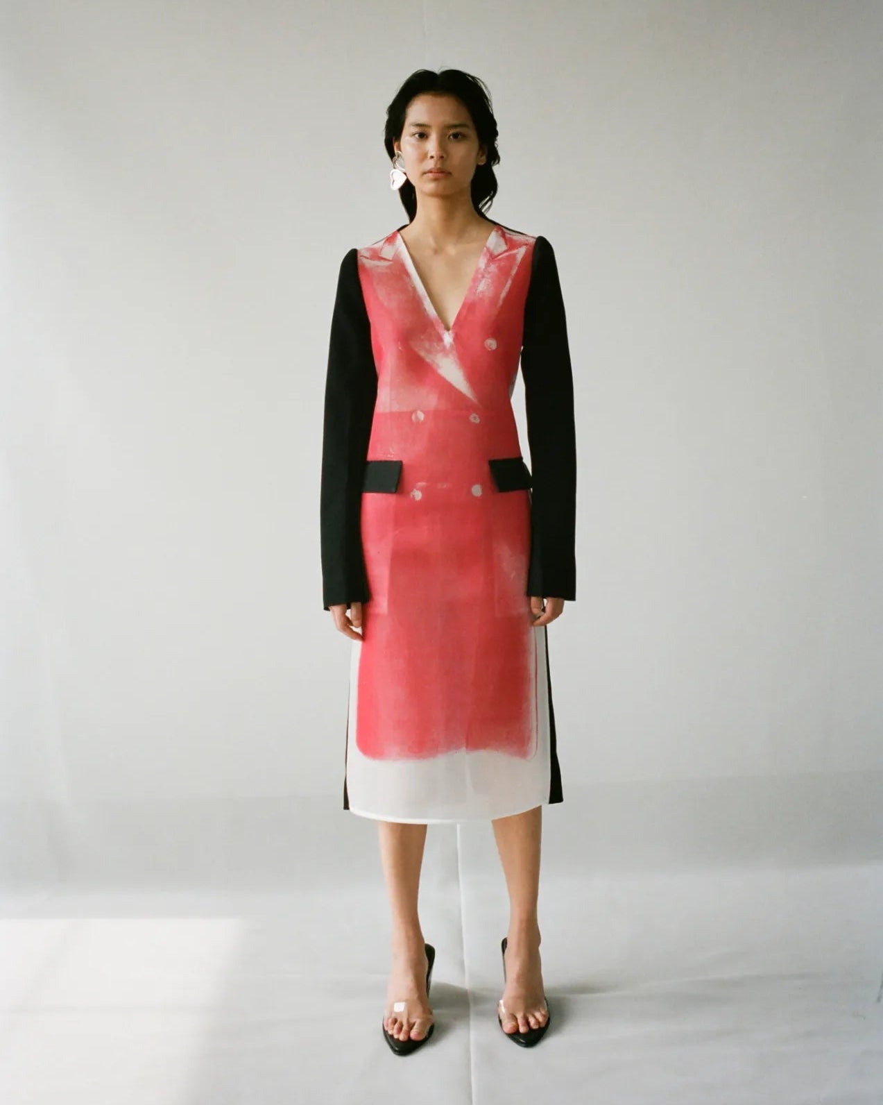 Woman wearing a black and red Peter Do dress with a white background