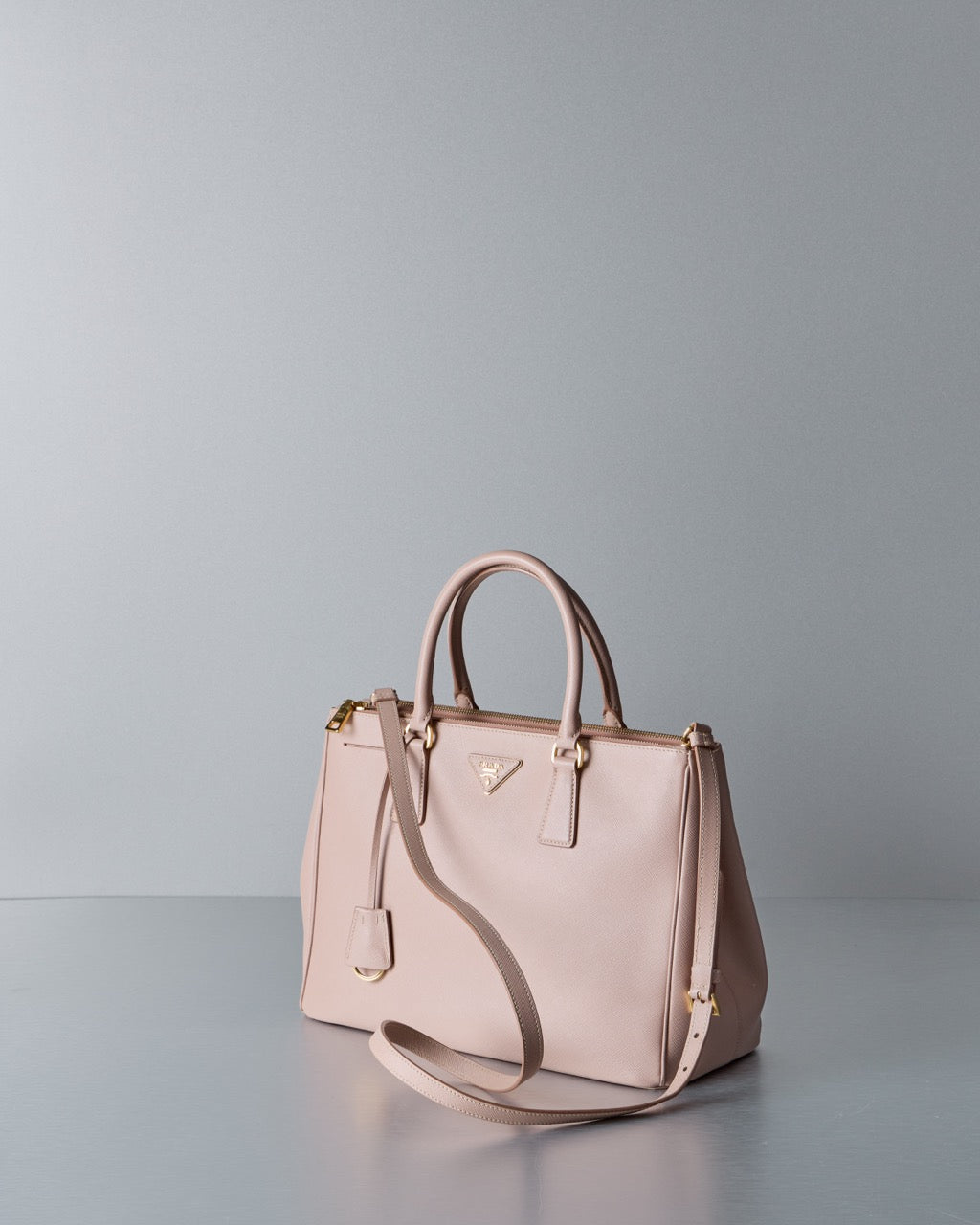 Pink Prada handbag on a light gray background