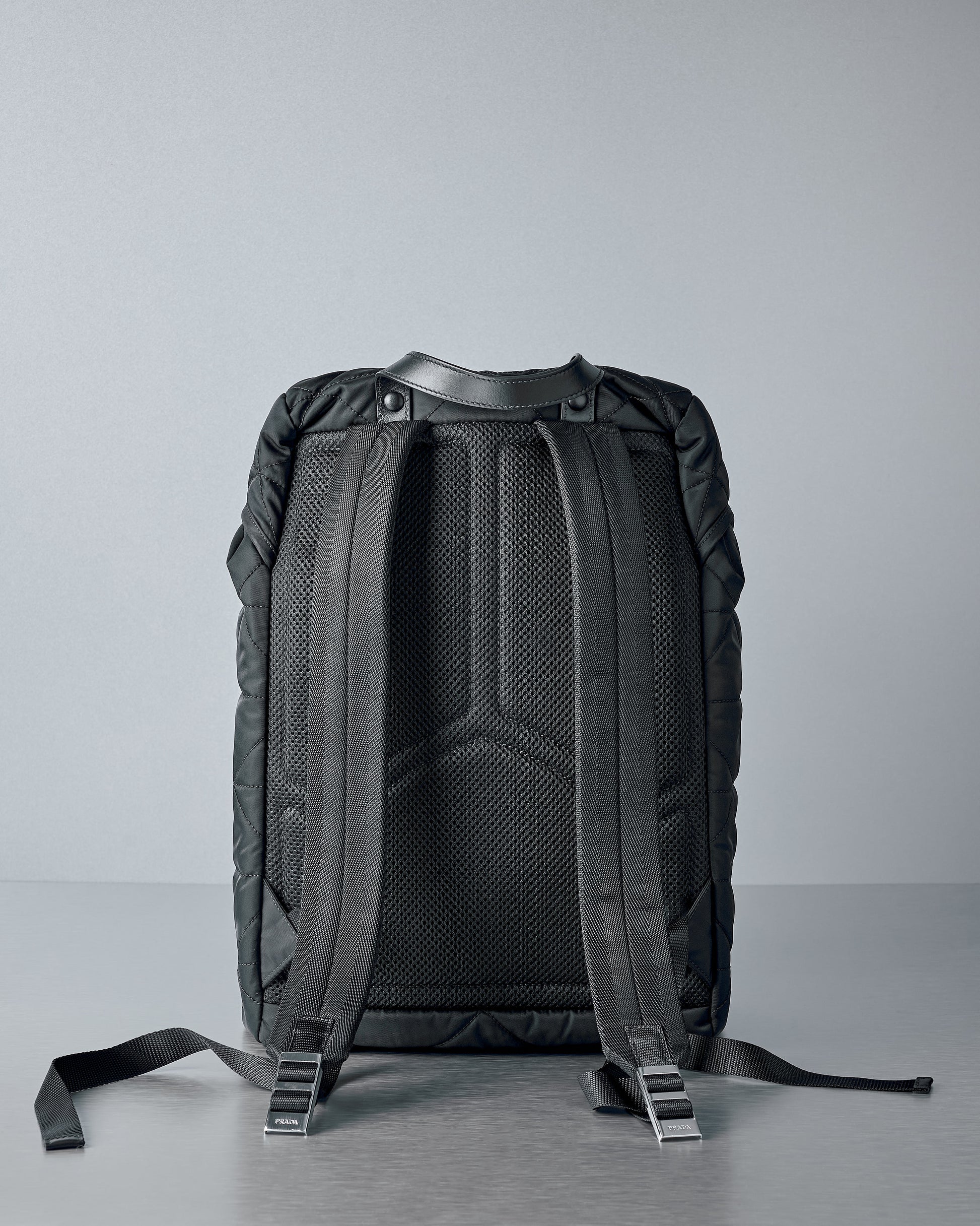 Black Prada backpack on a grey background