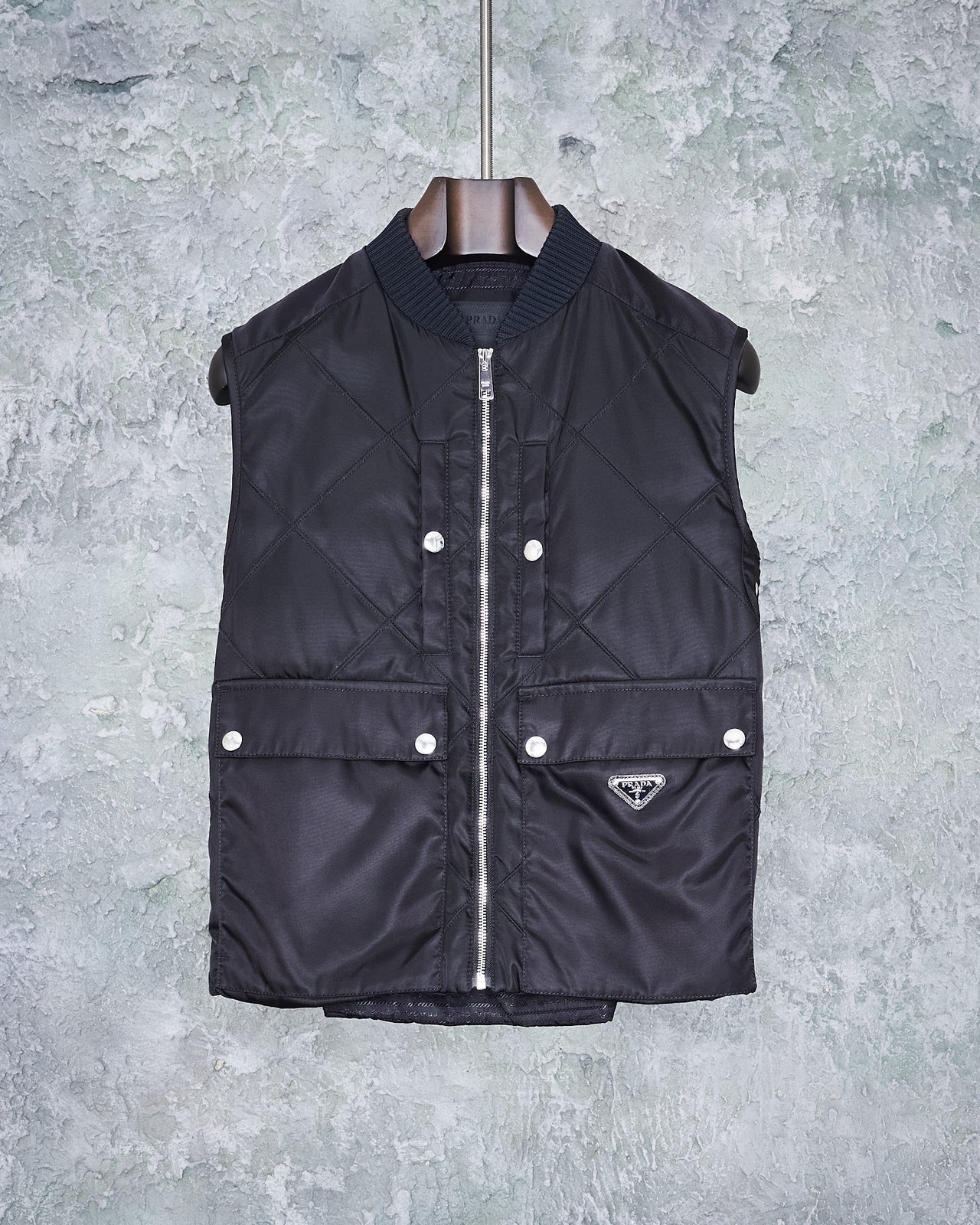 Black Prada quilted gilet vest with a front zip closure, four press stud pockets, and an Prada logo on waist.