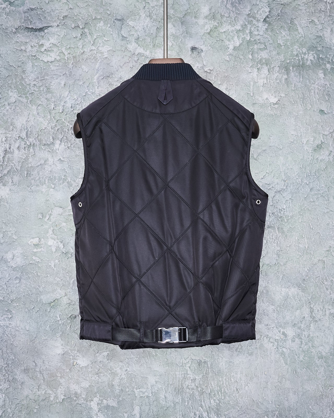 Black Prada quilted gilet vest with a front zip closure, four press stud pockets, and an Prada logo on waist.