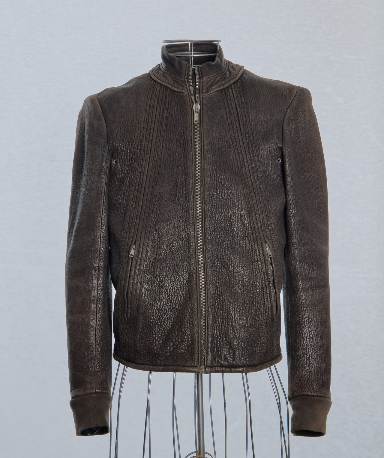 Brown leather Rick Owens jacket on a mannequin against a light gray background