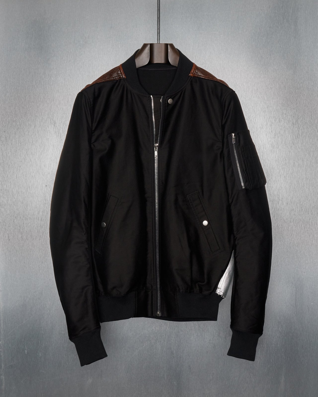 A black Rick Owens DRKSHDW flight jacket with multiple panels, a front zip closure, and several pockets.