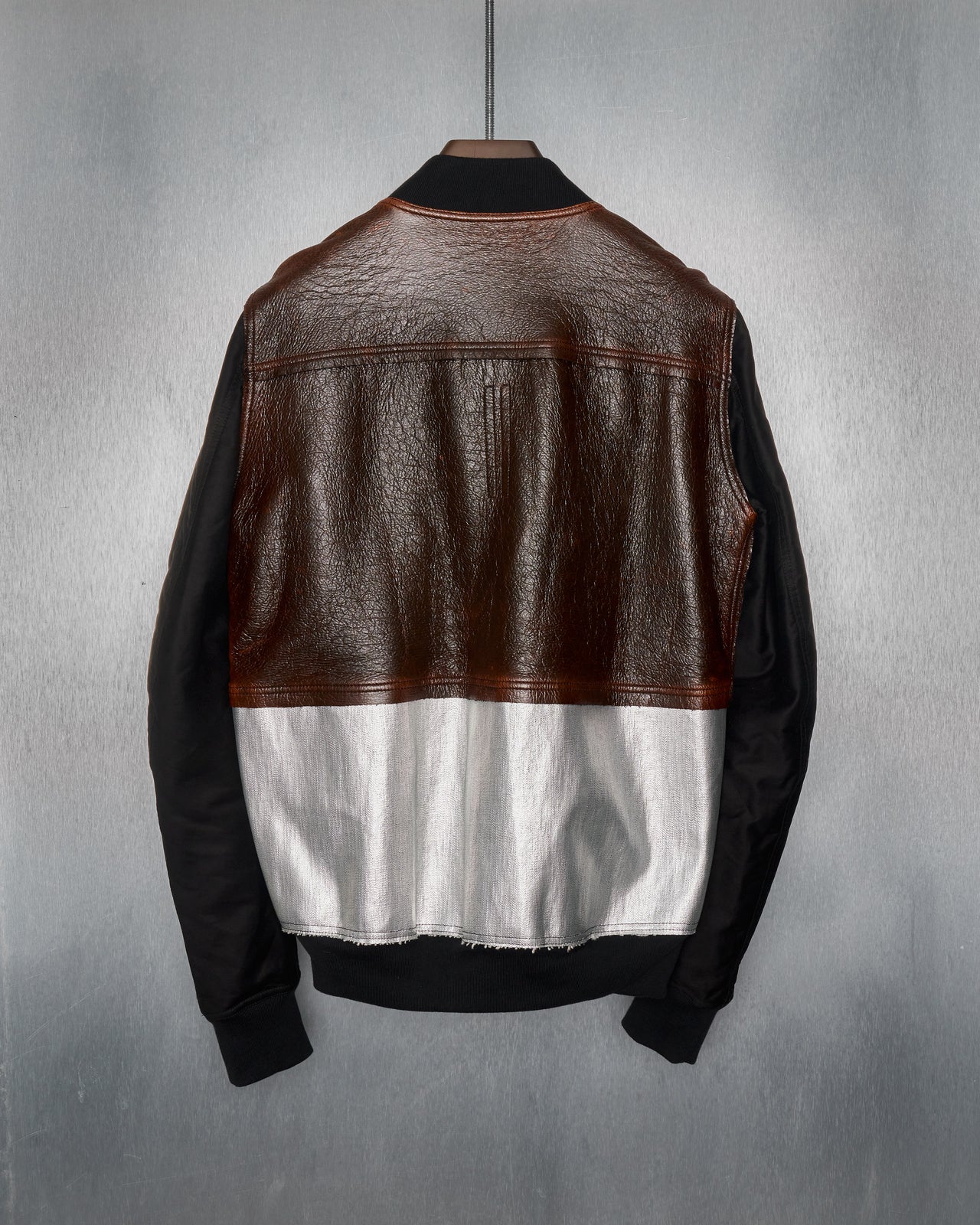 A black Rick Owens DRKSHDW flight jacket with multiple panels, a front zip closure, and several pockets.