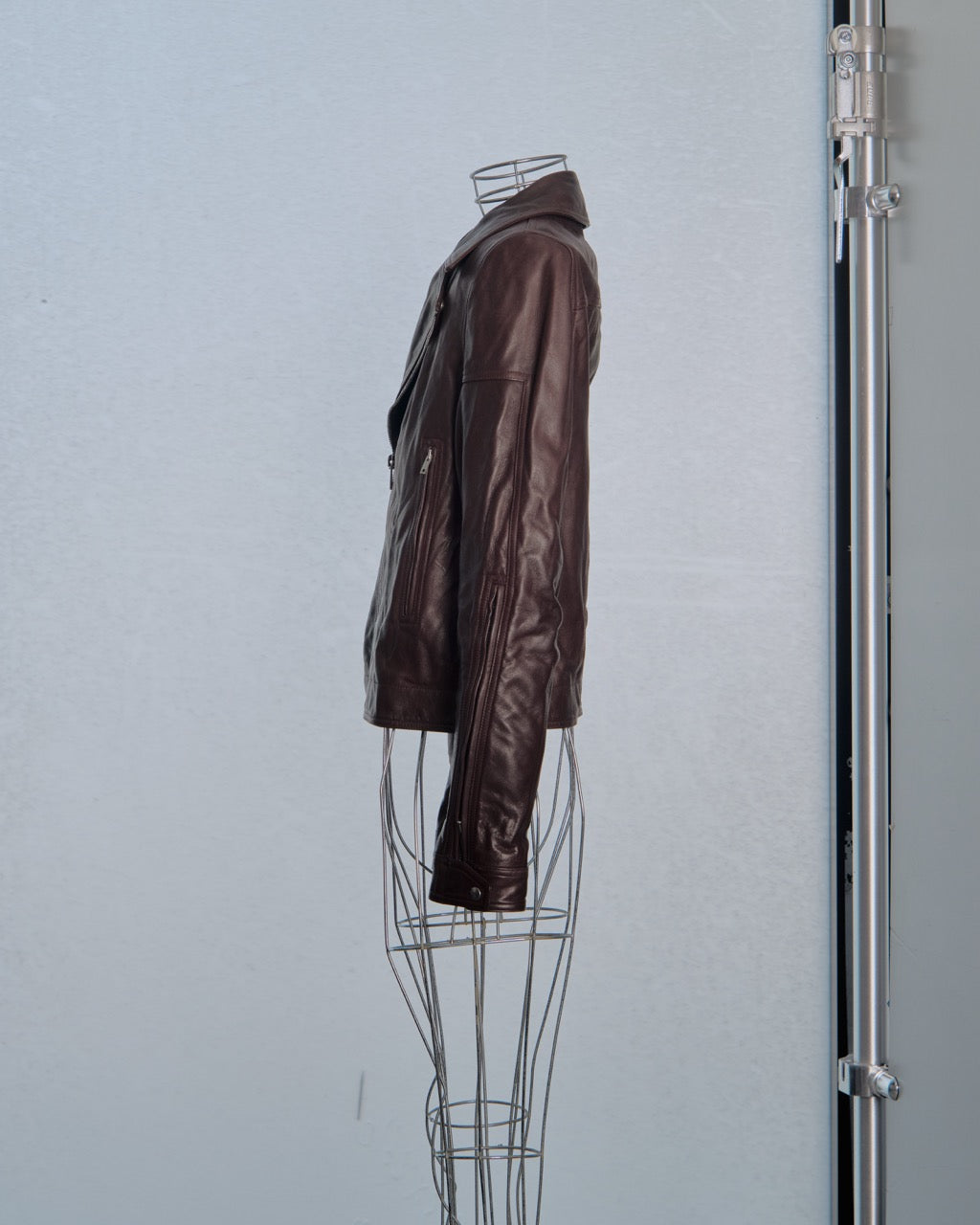 Brown leather Rick Owens jacket on a mannequin against a light gray background