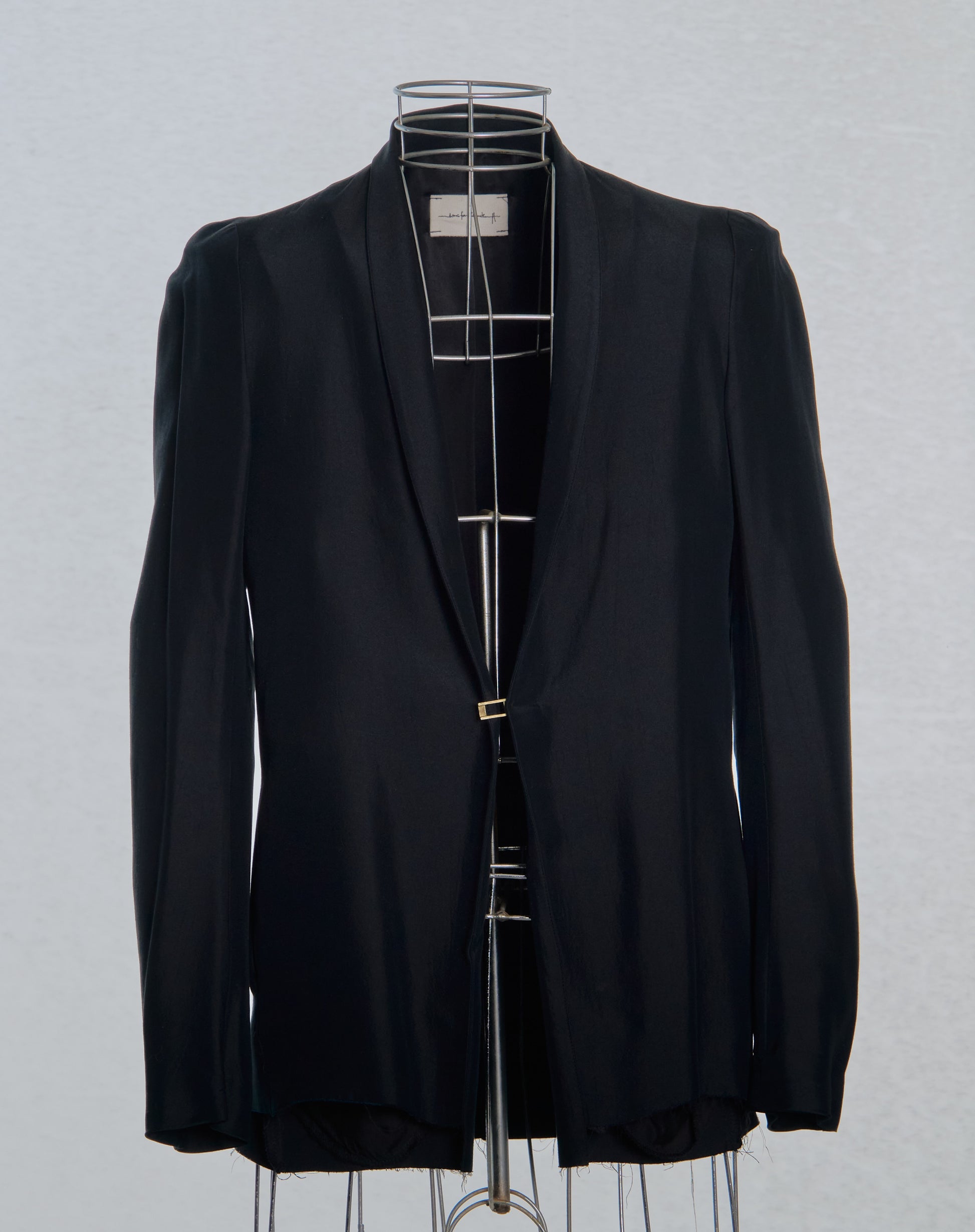 Black Song For The Mute blazer on a mannequin against a gray background