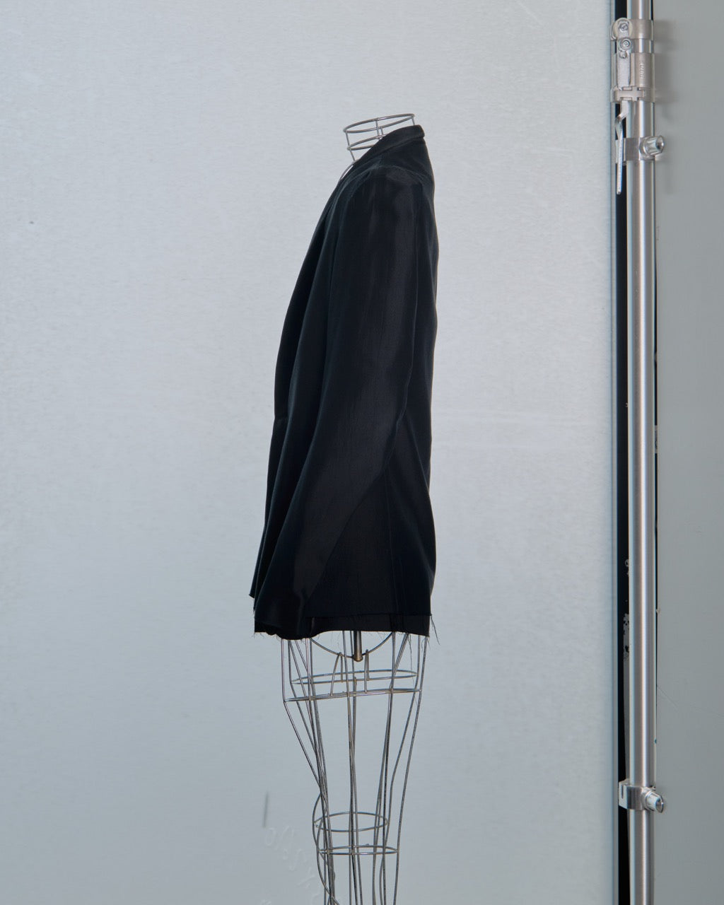 Black Song For The Mute shirt on a wire mannequin against a light gray background