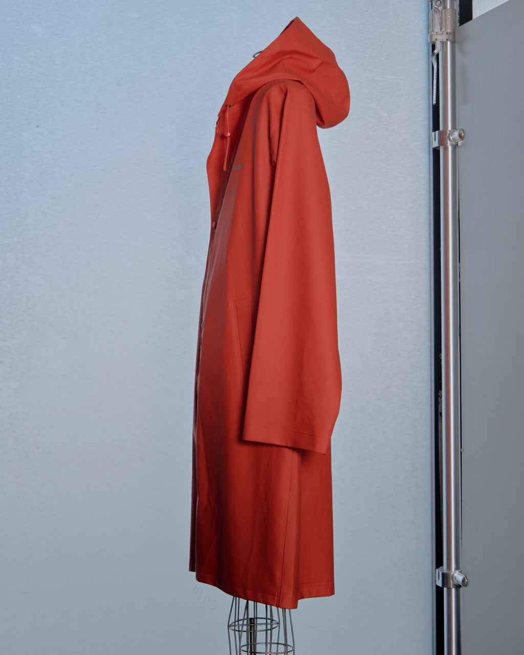 Red Vetements coat on a mannequin against a gray background