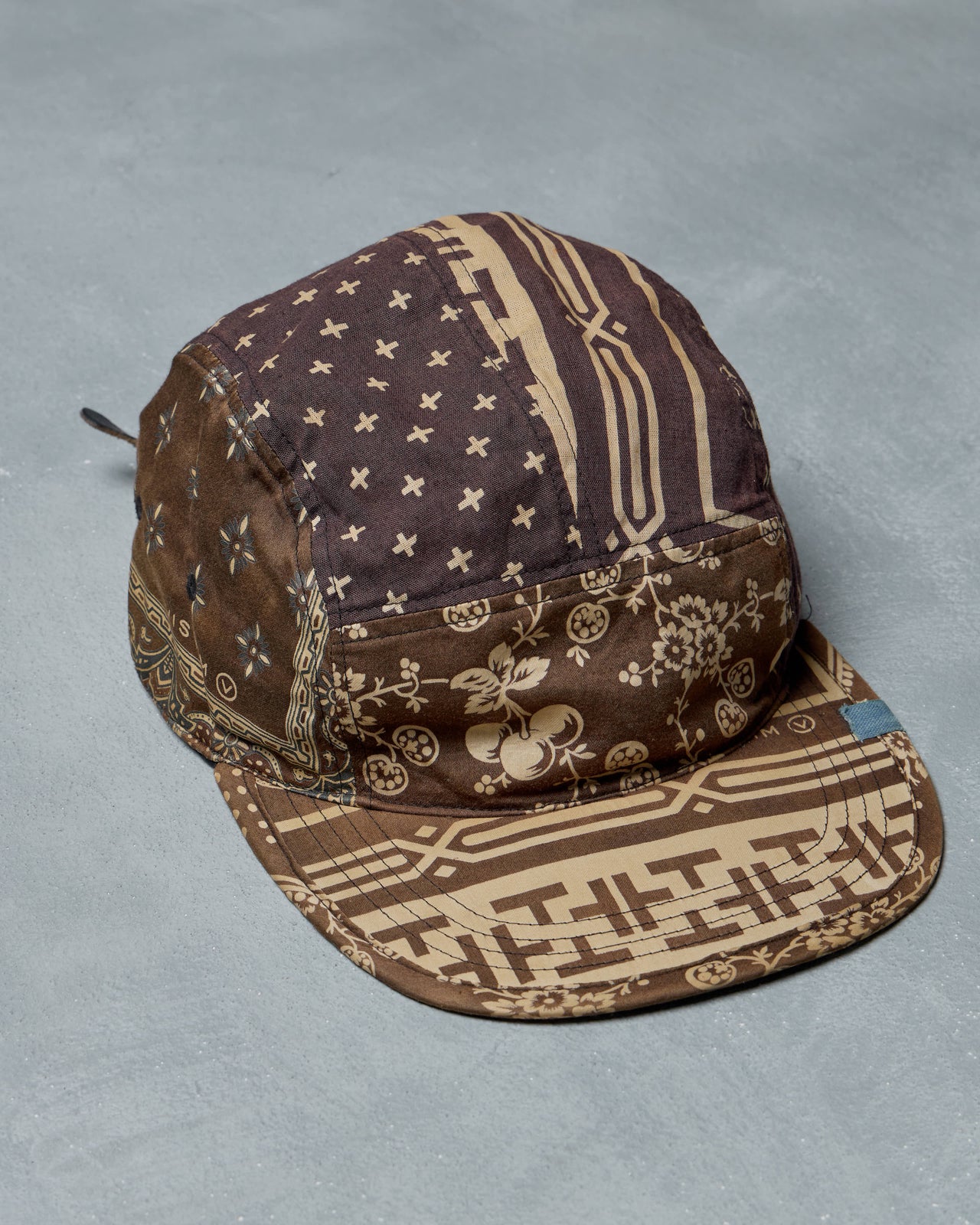 Patterned Visvim cap on a gray background