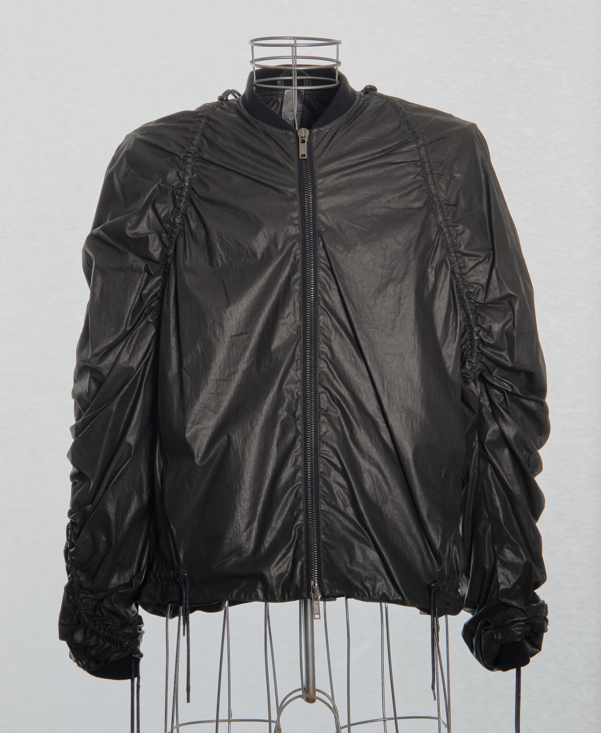 Brown Y/Project jacket on a mannequin against a white background