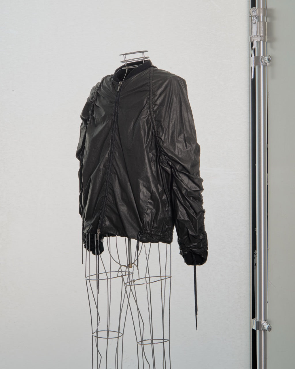 Black Y/Project jacket on a mannequin against a white background