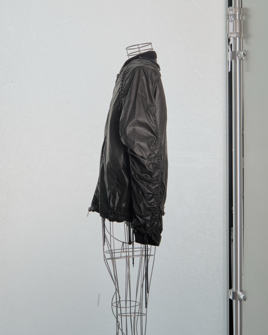 Black Y/Project jacket on a mannequin against a white background