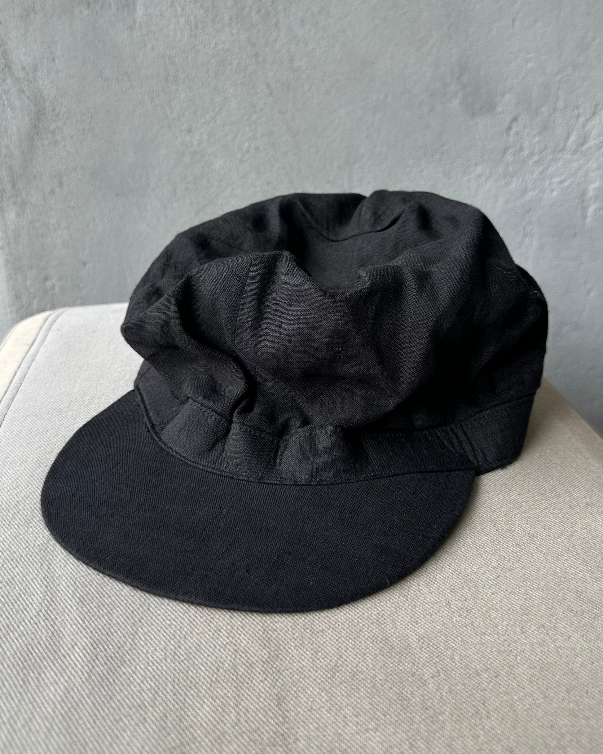 Black Y's By Yohji Yamamoto cap on a light gray surface with a neutral gray background