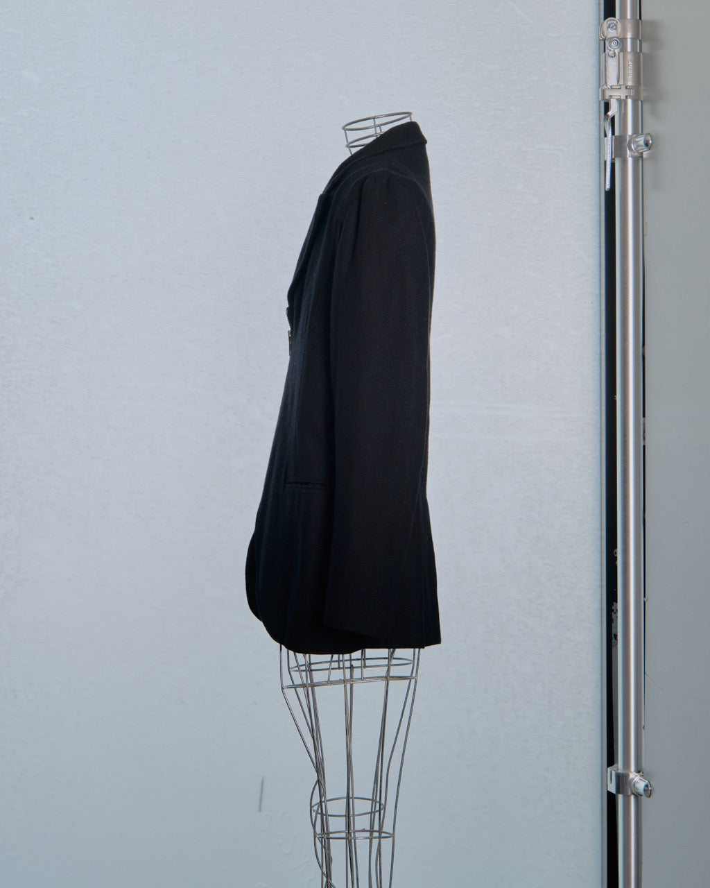 Black Yohji Yamamoto blazer on a mannequin against a light gray background