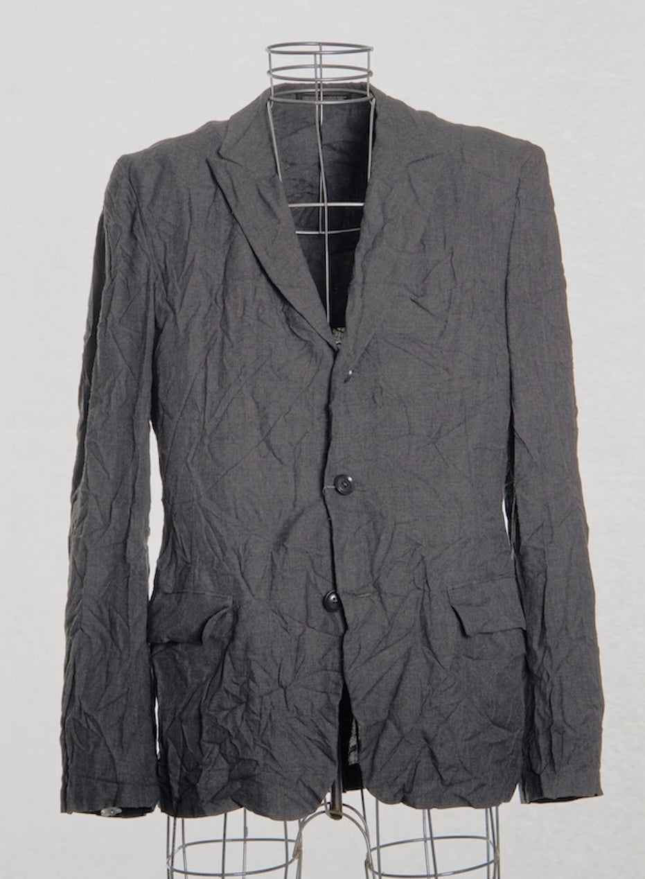 Gray textured Yohji Yamamoto blazer on a mannequin against a white background