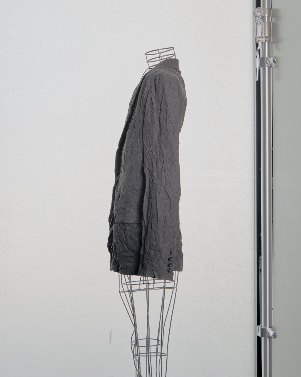 Gray Yohji Yamamoto jacket on a mannequin against a white background