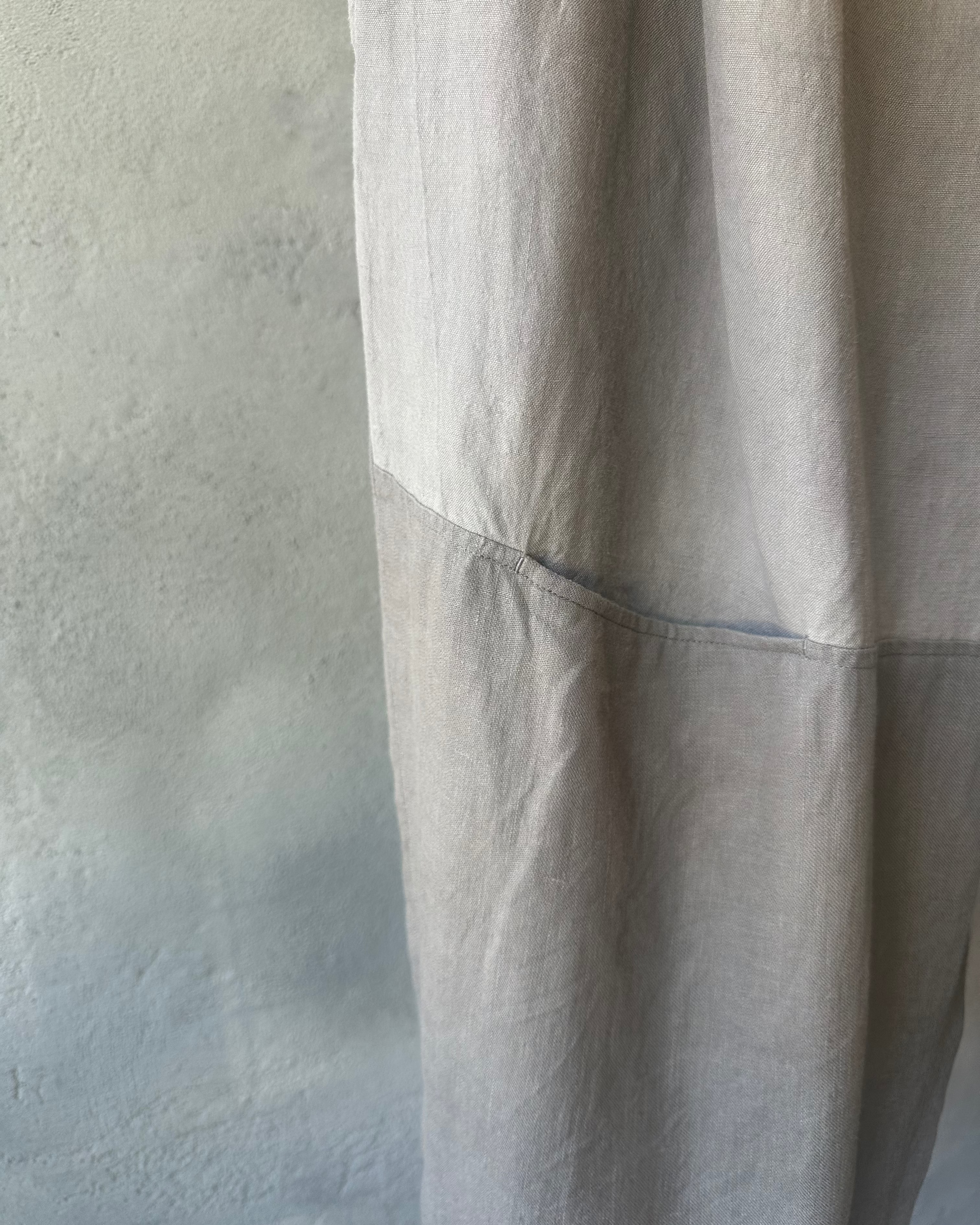 Light gray Yohji Yamamoto pants on a textured gray background