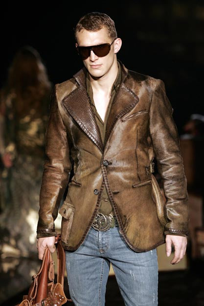 A brown leather Roberto Cavalli jacket with python skin lapels and trimming, featuring a two-button blazer design, tanned python skin patch on the chest, and multiple pockets.