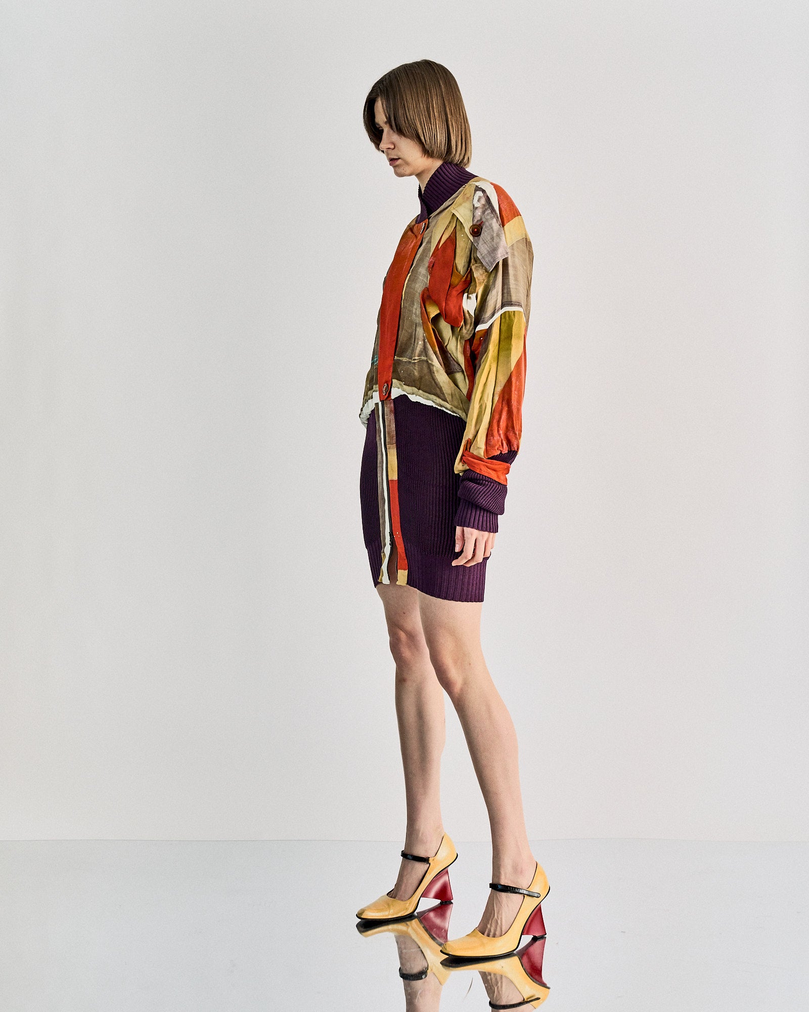 A person in a colourful, abstract-patterned Vivienne Westwood jacket.